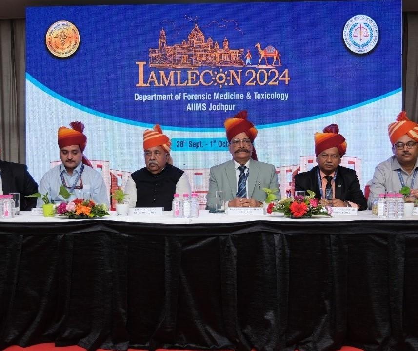  Panelists at a conference with a banner for IAMLECON 2024, AIIMS Jodhpur.
